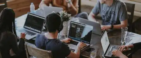 group of people using laptop computer